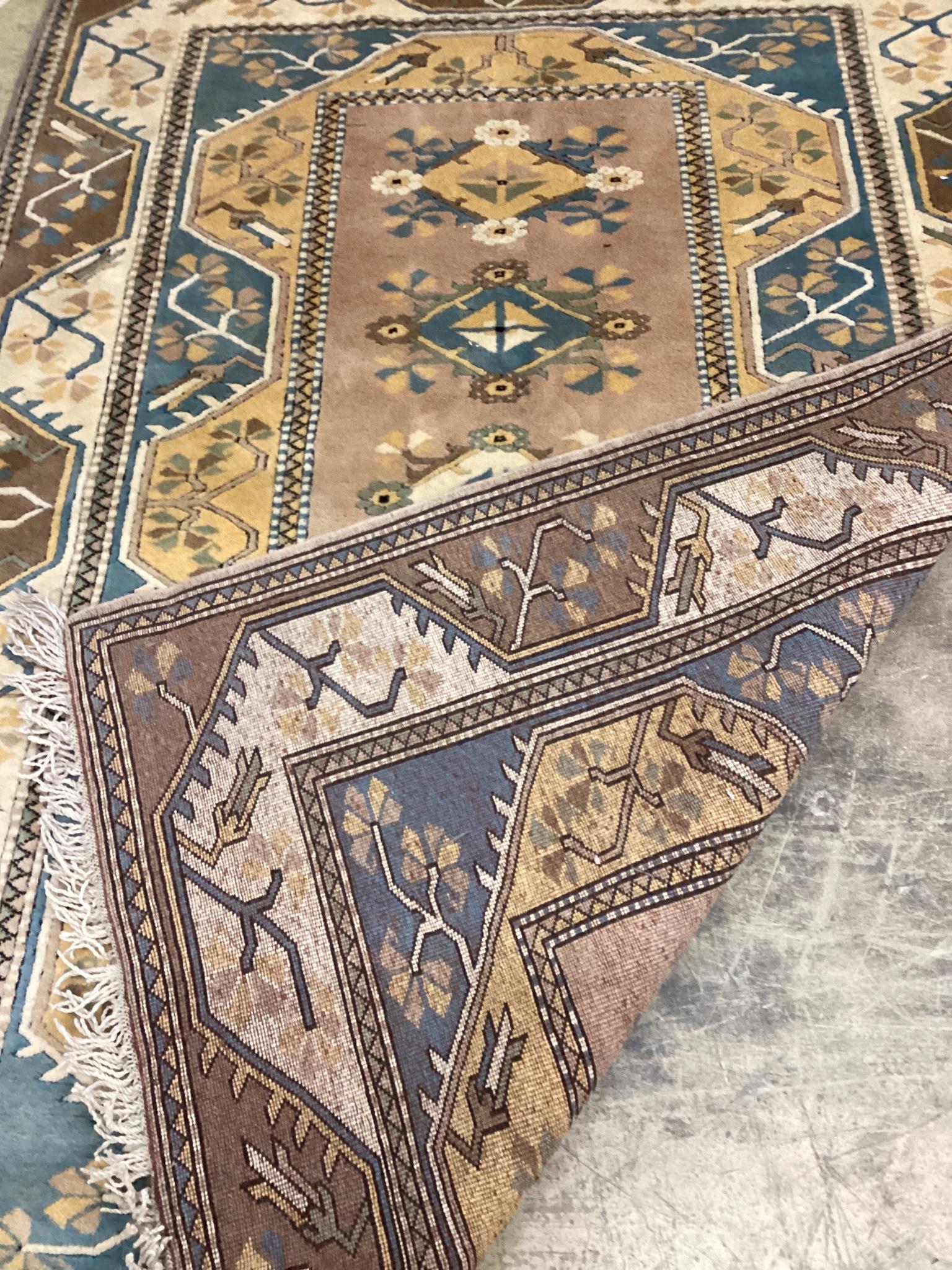 A modern Caucasian style fawn ground rug, 230 x 168cm